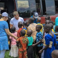 9-12-22_Kiboga Borehole5-Greeting Children